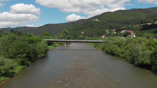 Bridge across Poprad river near village Rytro and Sucha Struga in summer at Beskid Sadecki Mountains background