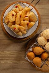 typical Brazilian food, fried cassava, cheese bread, snacks, guarana, beer
