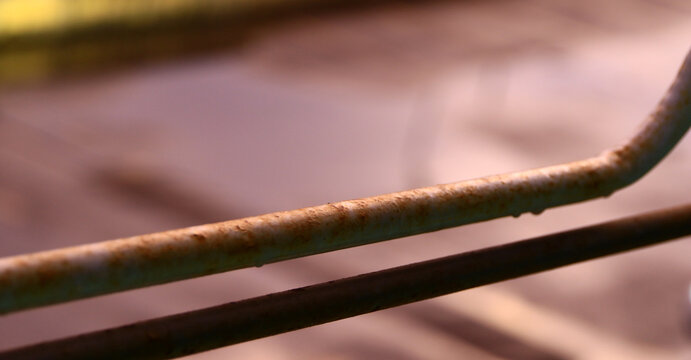 Rusty metal bars with stains on white background.