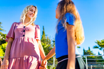 Fototapeta na wymiar blonde mom and her cute child in summer beach seaside in tropics