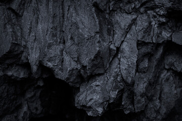 Black rock texture. Stone background. Old weathered mountain surface. Macro. Dark  grunge...