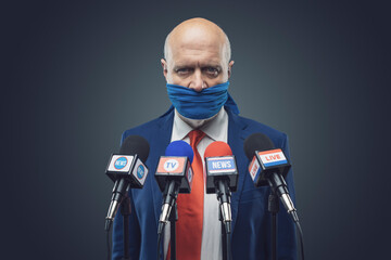 Angry politician with sealed mouth at the press conference - obrazy, fototapety, plakaty