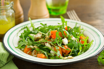 salad with pumpkin, feta and arugula. . Selective focus