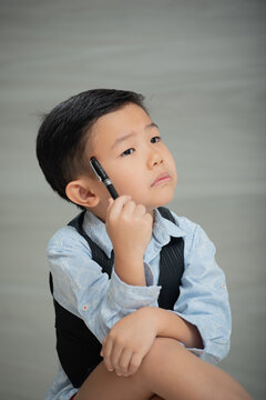 Asian boy, dressed smartly, looking intellectual

