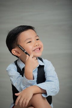 Asian boy, dressed smartly, looking intellectual
