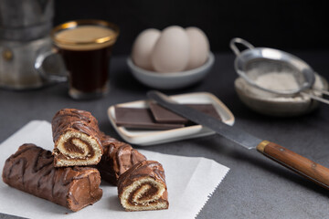 Homemade chocolate rolls made with dark chocolate with a coffee on the side.