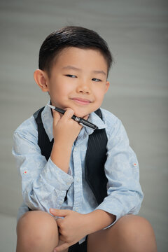 Asian boy, dressed smartly, looking intellectual
