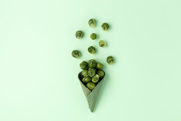 Creative fall layout made with broccoli and ice cream cone on pastel green background. Minimal vegetarian or vegan concept. Healthy eating. Flat lay, top view, copy space, banner.