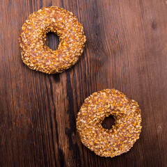 Glazed chocolate-coated doughnuts with sprinkles on a wooden Board,space for text,