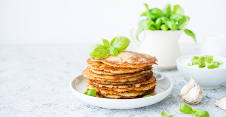 Potato pancakes with herbs and sour cream, Russian, Belarusian cuisine, selective focus