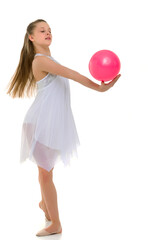 little girl is engaged in fitness with a ball.