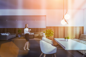 Woman walking in white and wooden dining room