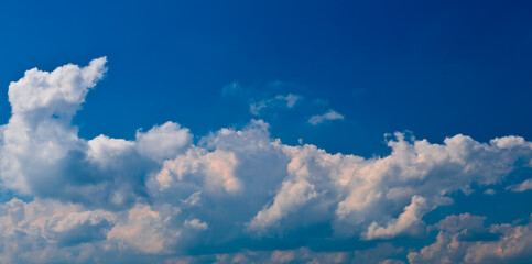 fluffy white clouds and blue sky