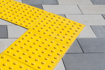 Yellow blocks of tactile paving for blind handicap. Braille blocks, tactile tiles for the visually...
