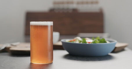 soda drink from a bottle into highball glass on concrete countertop with copy space