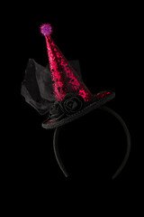 Halloween hat shiny on black background.Bright cap on the hoop.