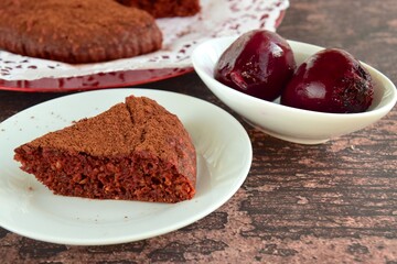 Beetroot chocolate cake with cacao powder on wooden background