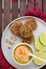 Delicious quinoa jalapeño bean burger patties with chili mayonnaise dip garnish with lime
