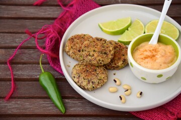 Delicious quinoa jalapeño bean burger patties with chili mayonnaise dip garnish with lime