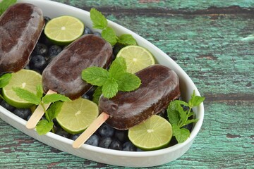 Fresh organic blueberry lime mint popsicles
