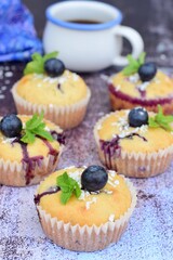 Blueberry coconut muffins garnish with mint leaves
