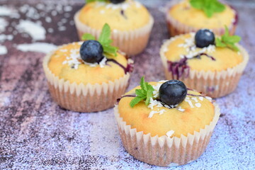 Blueberry coconut muffins garnish with mint leaves
