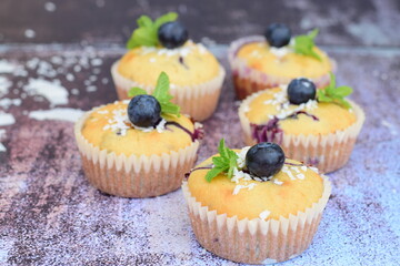Blueberry coconut muffins garnish with mint leaves
