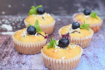 Blueberry coconut muffins garnish with mint leaves
