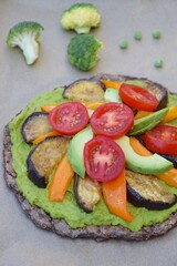 Broccoli pizza with mashed pea, eggplant, yellow bell pepper, avocado and tomato