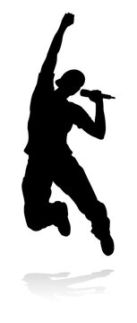 A singer pop, country music, rock star or hiphop rapper artist vocalist singing in silhouette