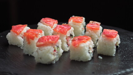 Sushi rotate.Macro set of fresh Philadelphia sushi from fish, salmon, rice, cucumbers. Sushi restaurant, sushi delivery. Selective focus