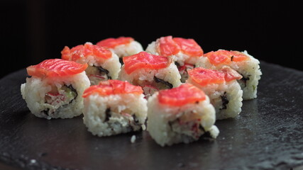 Sushi rotate.Macro set of fresh Philadelphia sushi from fish, salmon, rice, cucumbers. Sushi restaurant, sushi delivery. Selective focus