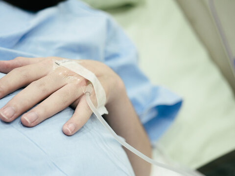 Pregnant Woman patient is waiting to deliver baby with drip receiving a saline solution on bed  at hospital, selective focus. Health Care concept, insurance concept, mother concept