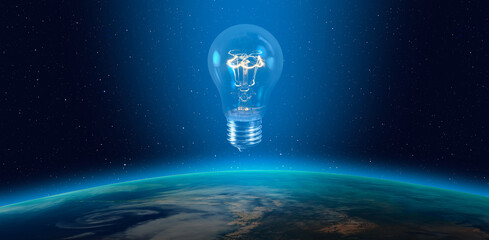 Light bulb over Earth planet, lot of stras in the background  "Elements of this image furnished by NASA"