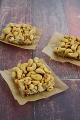 Cashew nut square bars on wooden background
