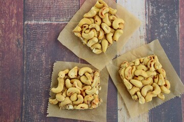Cashew nut square bars on wooden background
. Top view