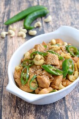 Stir-fried chicken with cashew nuts, green chili and sesame seeds