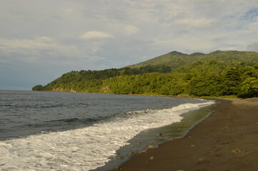 The lush jungle landscapes with waterfalls and black volcanic beaches on the St Vincent and Grenadines islands, Caribbean Ocean