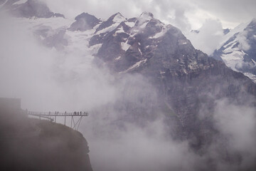 Fototapeta premium Fog covering Jungfrau mountain in the Valais Alps of Switzerland. 