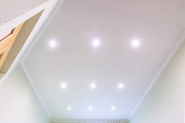 White beautiful matte stretch ceiling in the interior of the hall