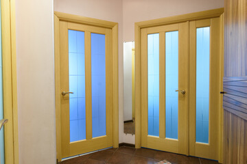 View from the corridor to the interior doors in a one-room apartment