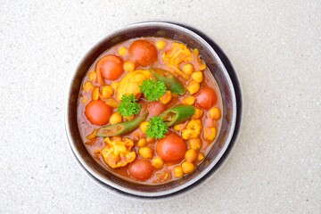 Spicy chickpea cauliflower tomato soup with green chili and parsley
