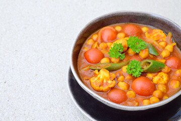 Spicy chickpea cauliflower tomato soup with green chili and parsley
