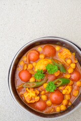 Spicy chickpea cauliflower tomato soup with green chili and parsley
