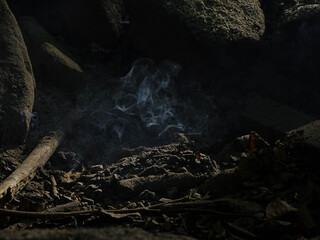 Smoke in the light inside the campfire pit