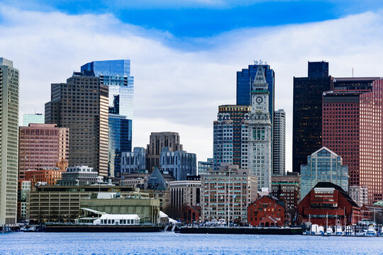 Boston city downtown view with clocktower from East side of the inner harbor Massachusetts, USA