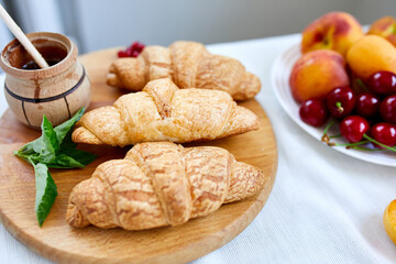 Traditional French croissant on white table background