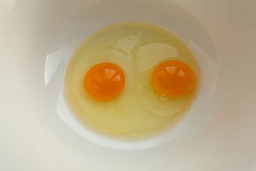 Raw eggs in a bowl for making an omelet or dough, top view