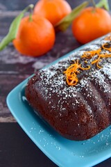 Chocolate almond clementine cake garnish with powdered sugar and zest
