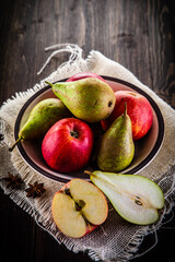 Autumn fruits - apples and pears on wooden table
